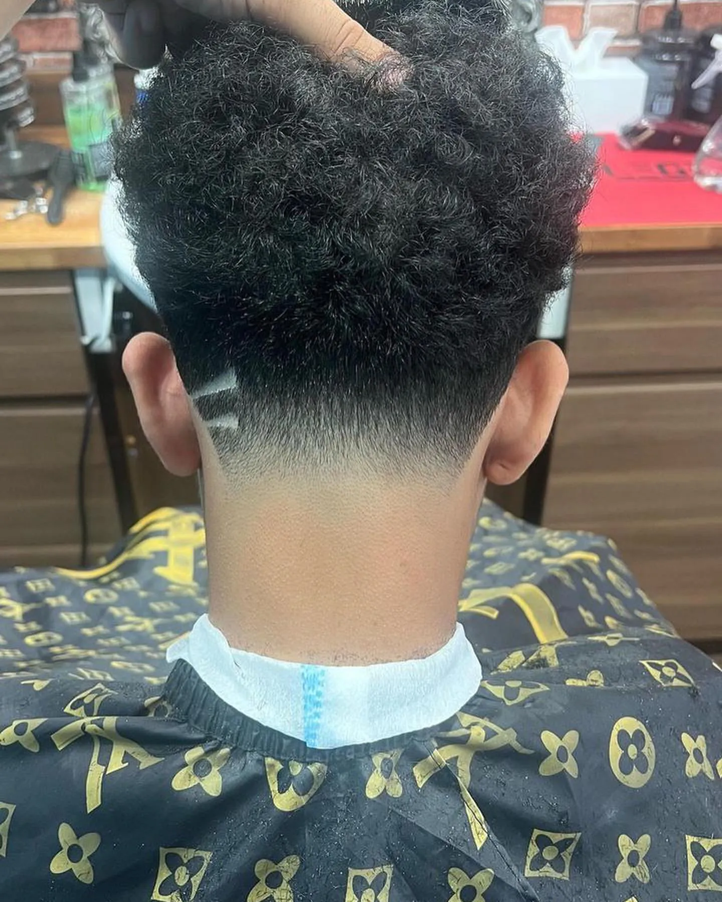 A textured crop with a skin fade, from the back